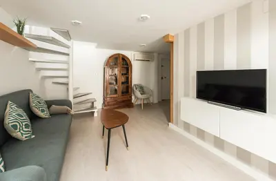 Una televisión o centro de entretenimiento en El Apartamento del Sol