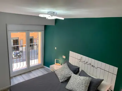 Cama o camas de una habitación en Madrid Villa Suites Aquamarina