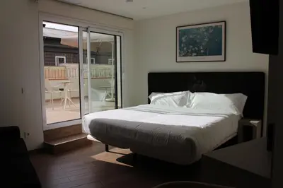 Cama o camas de una habitación en Apartamentos Centro Jardines