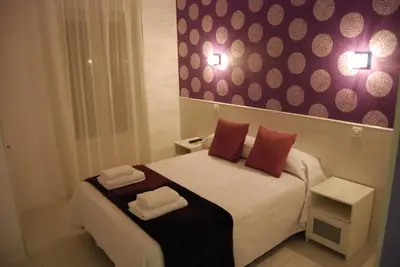 Cama o camas de una habitación en Hostal PETITE MAMAN