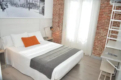 Cama o camas de una habitación en Hostal San Lorenzo