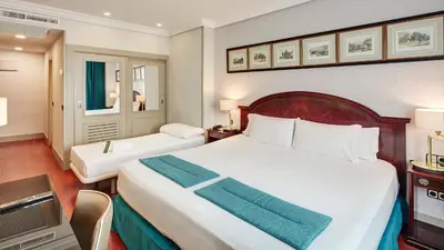 Cama o camas de una habitación en Sercotel Gran Hotel Conde Duque