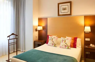 Cama o camas de una habitación en Suites Barrio de Salamanca