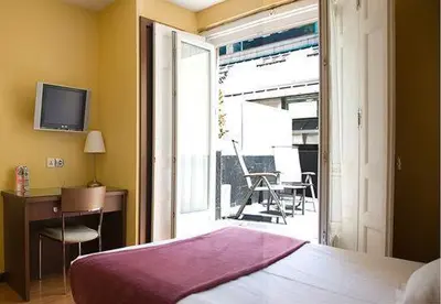 Cama o camas de una habitación en Hostal Astoria