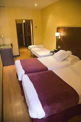 Cama o camas de una habitación en Hostal Astoria