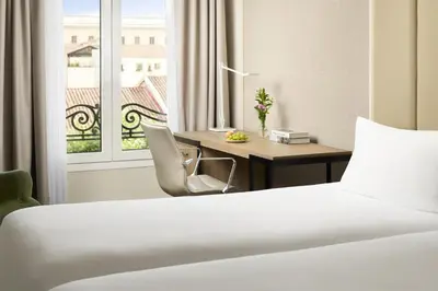 Cama o camas de una habitación en NH Madrid Nacional