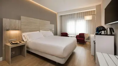Cama o camas de una habitación en NH Madrid Chamberí