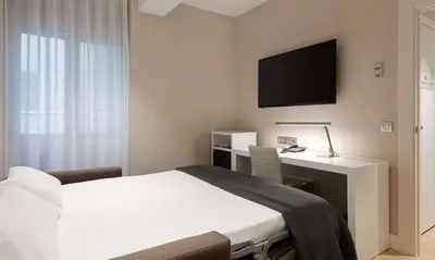 Cama o camas de una habitación en NH Madrid Chamberí