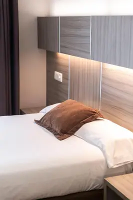 Cama o camas de una habitación en Hotel Serrano