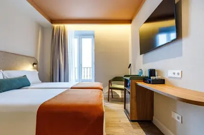 Cama o camas de una habitación en Petit Palace Puerta del Sol