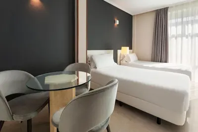 Cama o camas de una habitación en Sercotel Togumar