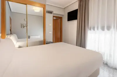 Cama o camas de una habitación en Sercotel Togumar