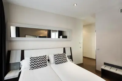 Cama o camas de una habitación en Petit Palace Triball