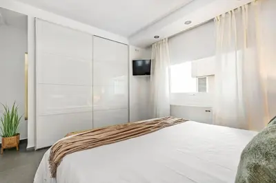 Cama o camas de una habitación en New Heima Colon Square