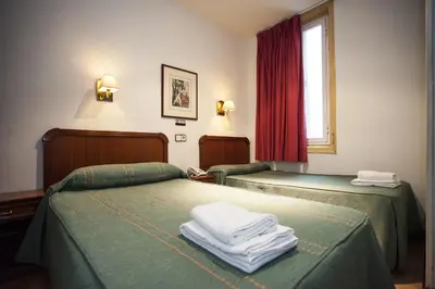 Cama o camas de una habitación en Pensión Carrera