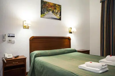 Cama o camas de una habitación en Pensión Carrera