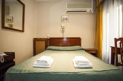 Cama o camas de una habitación en Pensión Carrera