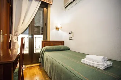 Cama o camas de una habitación en Pensión Carrera