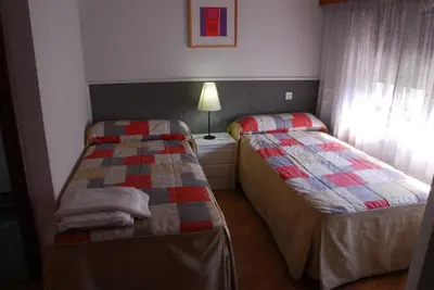 Cama o camas de una habitación en Apartamentos Goya 75