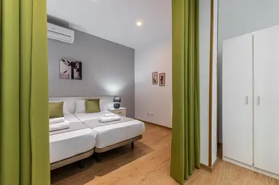 Cama o camas de una habitación en Waou Apartamentos en Sol Confort 4