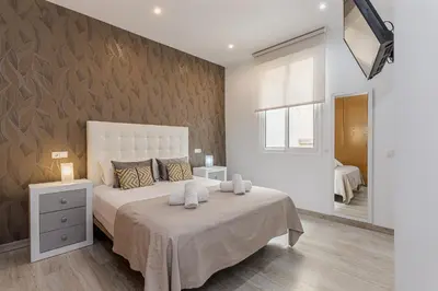 Cama o camas de una habitación en Waou Apartamentos en Sol Confort 9