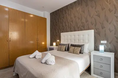 Cama o camas de una habitación en Waou Apartamentos en Sol Confort 9