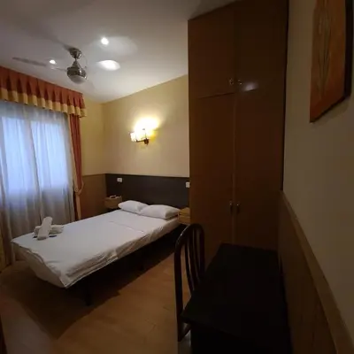 Cama o camas de una habitación en Hostal Oporto