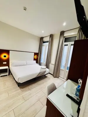 Cama o camas de una habitación en Hostal Cervelo