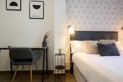 Cama o camas de una habitación en Apartamentos Fuencarral