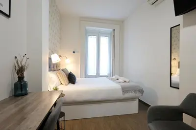 Cama o camas de una habitación en Apartamentos Fuencarral