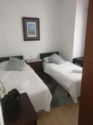 Cama o camas de una habitación en Apartamento HOTEL MONTAÑA LAVAPIES