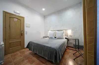 Cama o camas de una habitación en Hostal Las Fuentes