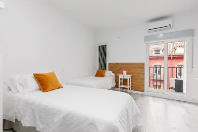 Cama o camas de una habitación en Los Apartamentos Jacinto Benavente Centro Madrid